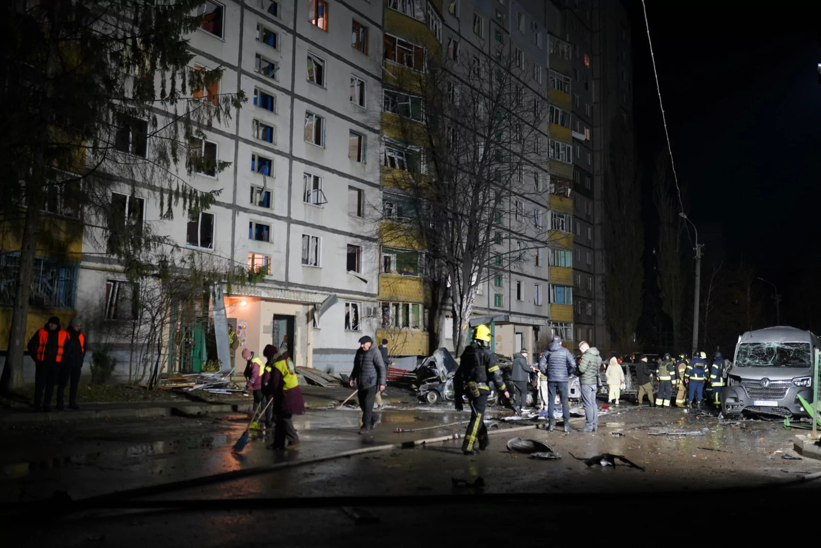 Proper gathered near damaged residential building in Kharkiv after Russian attack