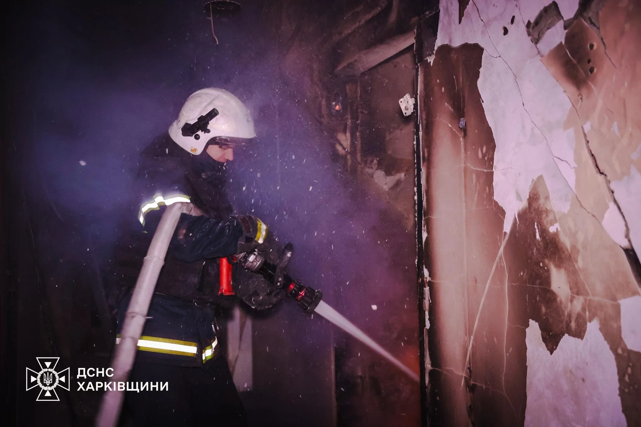 A firefighter extinguishes a fire after a Russian attack on Kharkiv