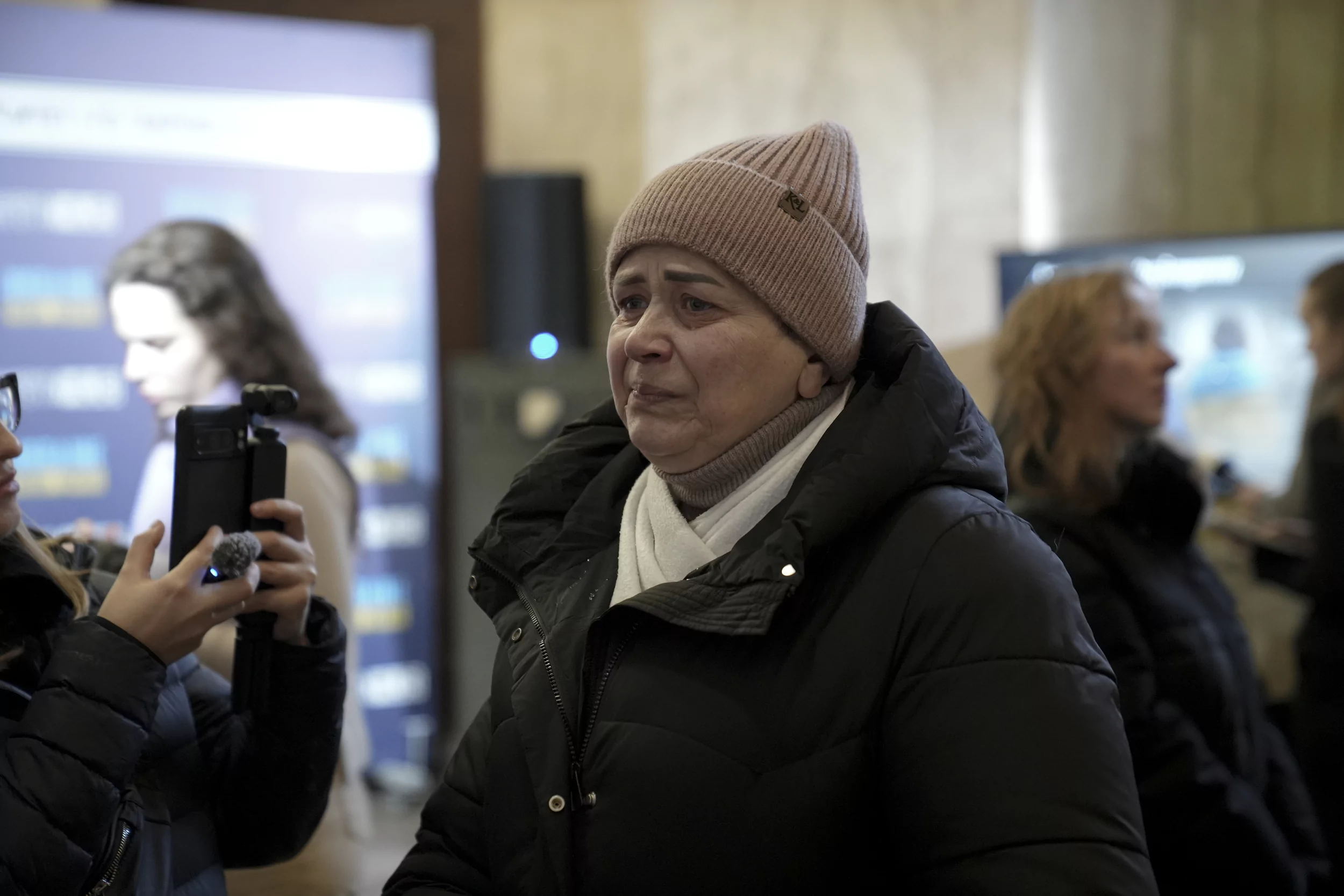 Woman looks at her killed by Russia grandson's photo