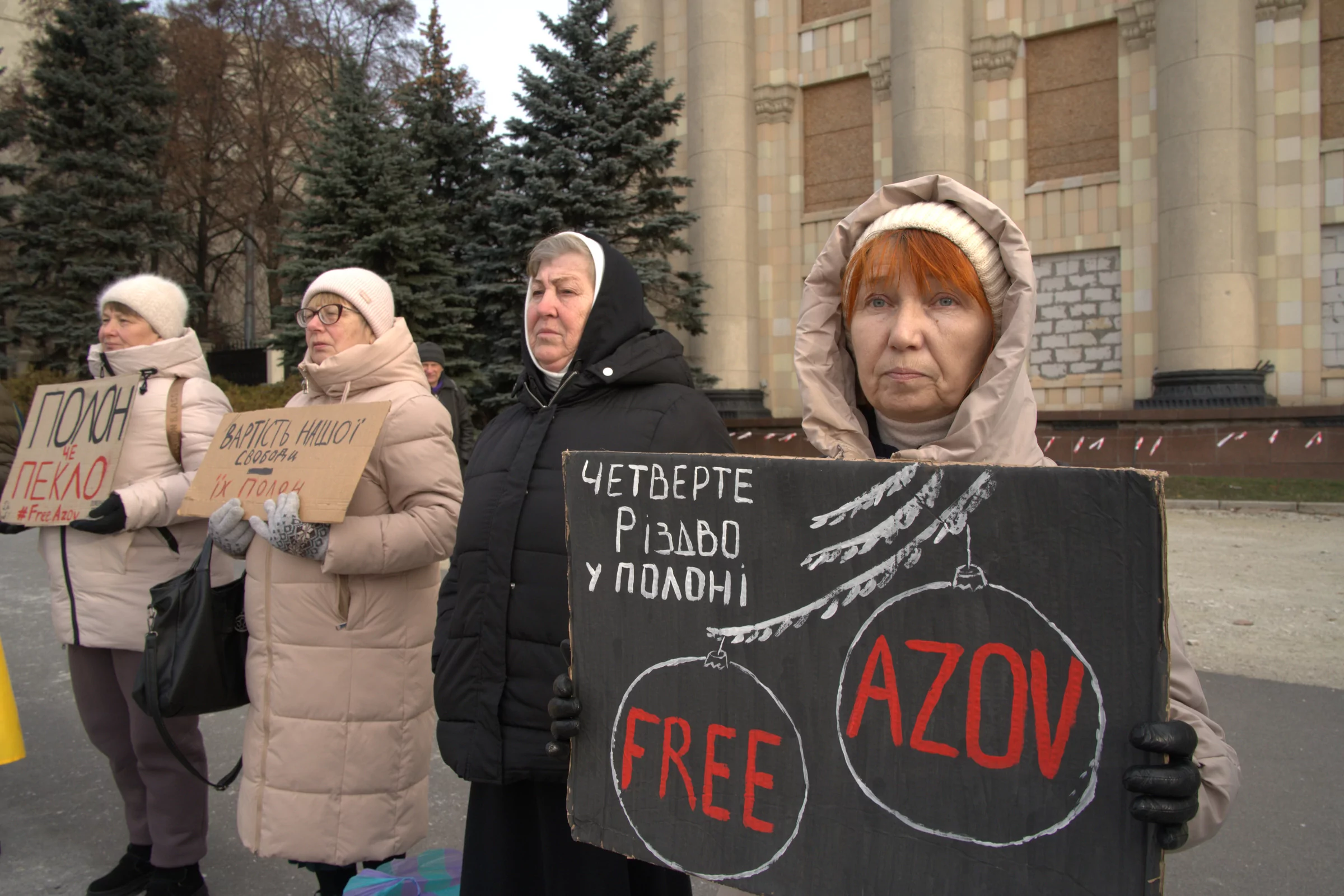 Fourth women in a raw hold cardboad signs on the demonstration