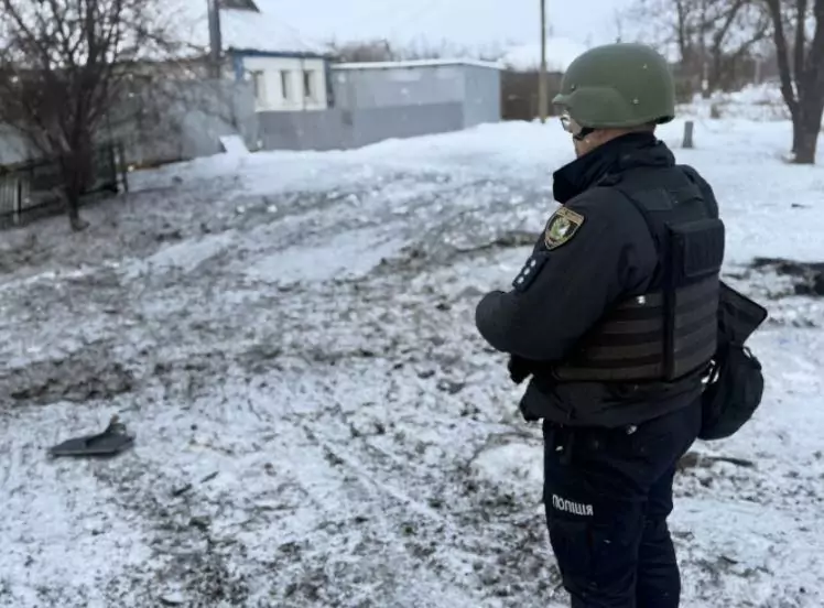 A police officer documents the consequences of a Russian attack on the Kupiansk district
