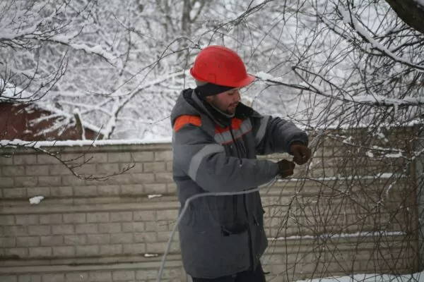 Photo of an electrician restoring power networks