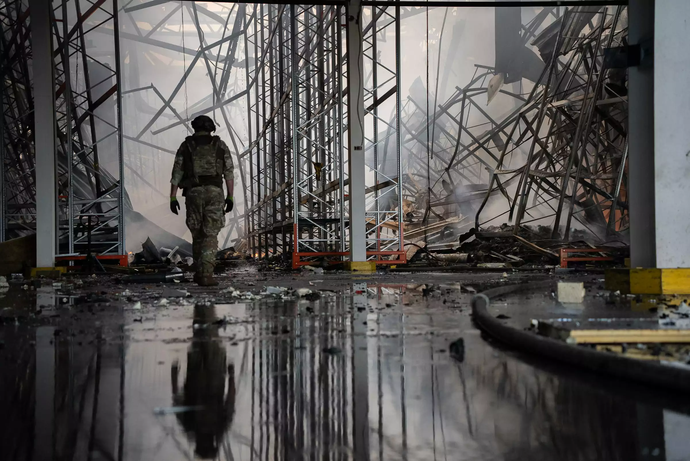 A pyrotechnician inspects a warehouse in Vasyshcheve in the Kharkiv region after a Russian attack. The fire covered an area of 20,000 square meters. One worker was killed, and four were injured. July 2025