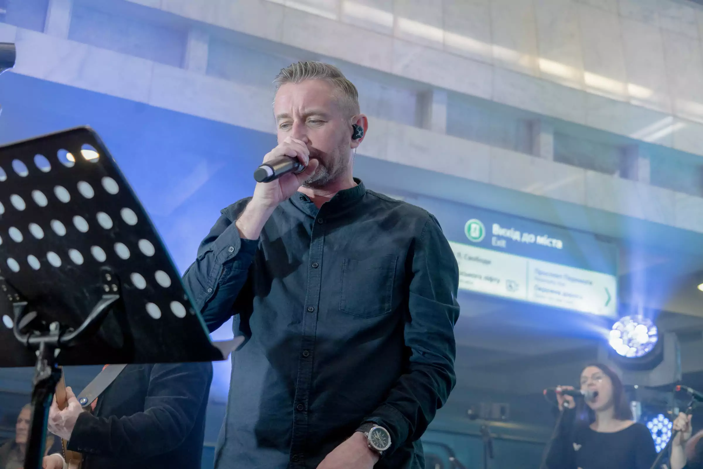 Middle-aged man, Serhii Zhadan, with a microphone on the underground station in Kharkiv