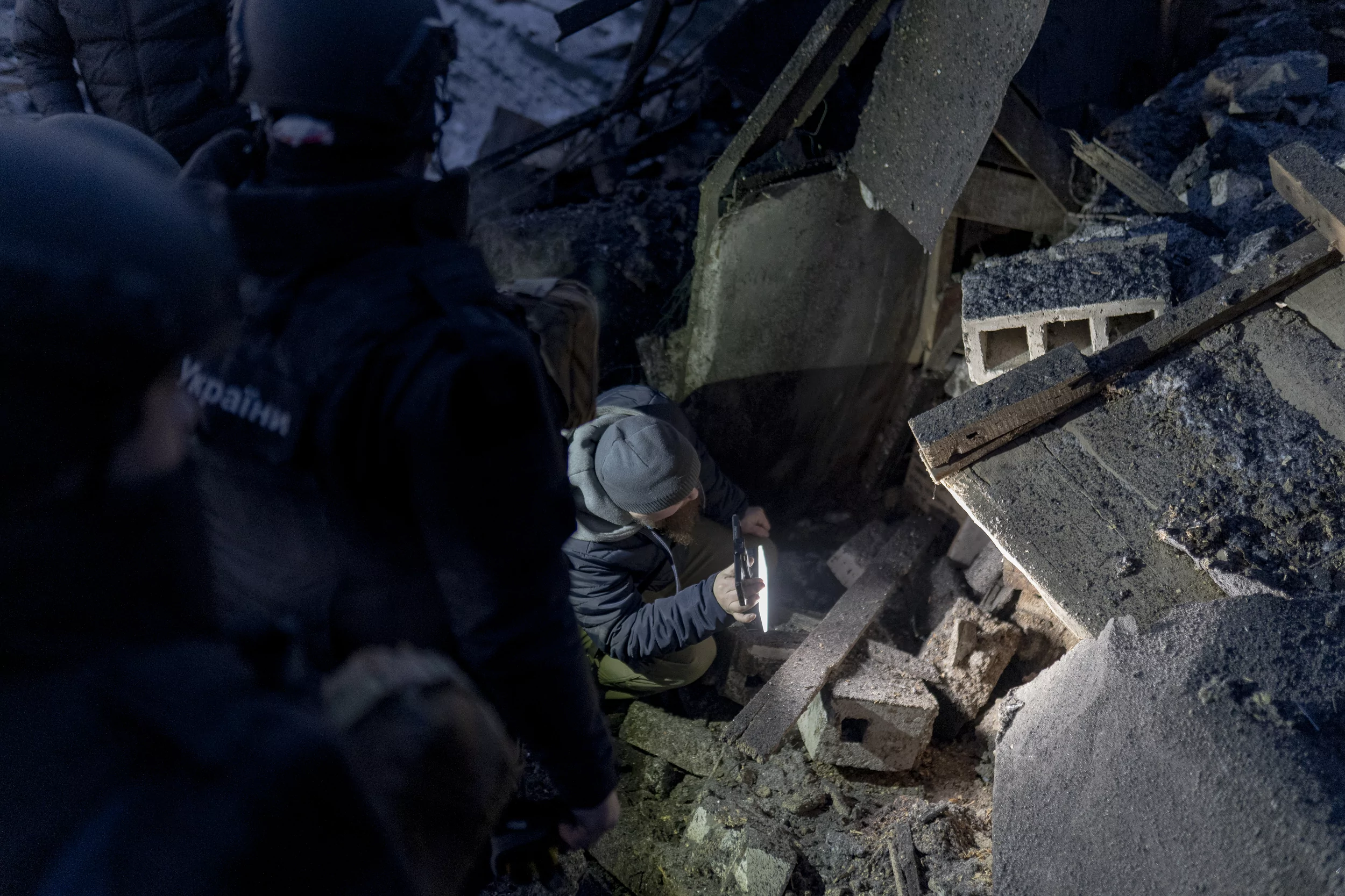 The workers of State Emergency Service looking through debris after Russian attack on Kharkiv