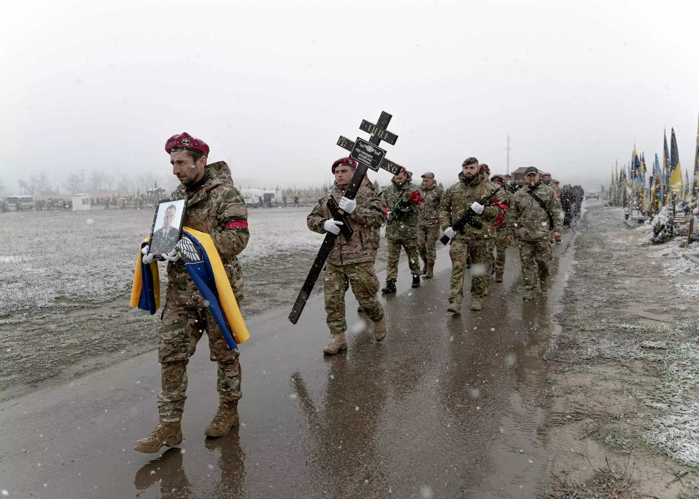Employees of a special unit of the police are carrying a photo and the cross of Lieutenant Vladyslav Svyrydov, killed in the Kupiansk direction. November 2025