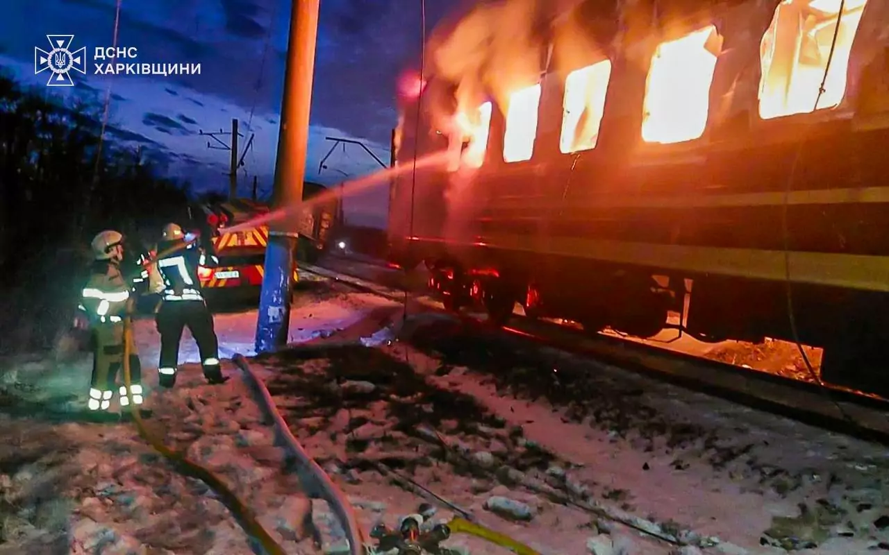 Firefighters extinguish a fire after Russian attack on a passenger train in the Kharkiv oblast