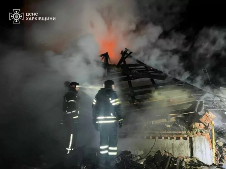 Firefighters extinguish a house on fire after it was hit by a Russian drone in Bohodukhiv