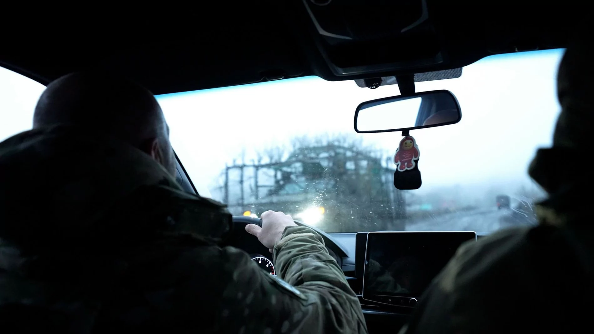 A military armored vehicle drives toward the White Angel team