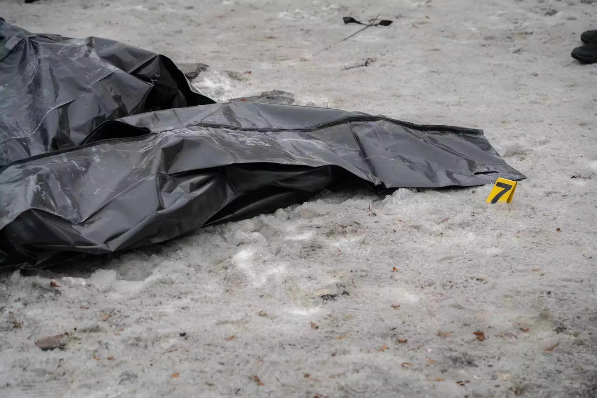 Body bag with a number seven nearby