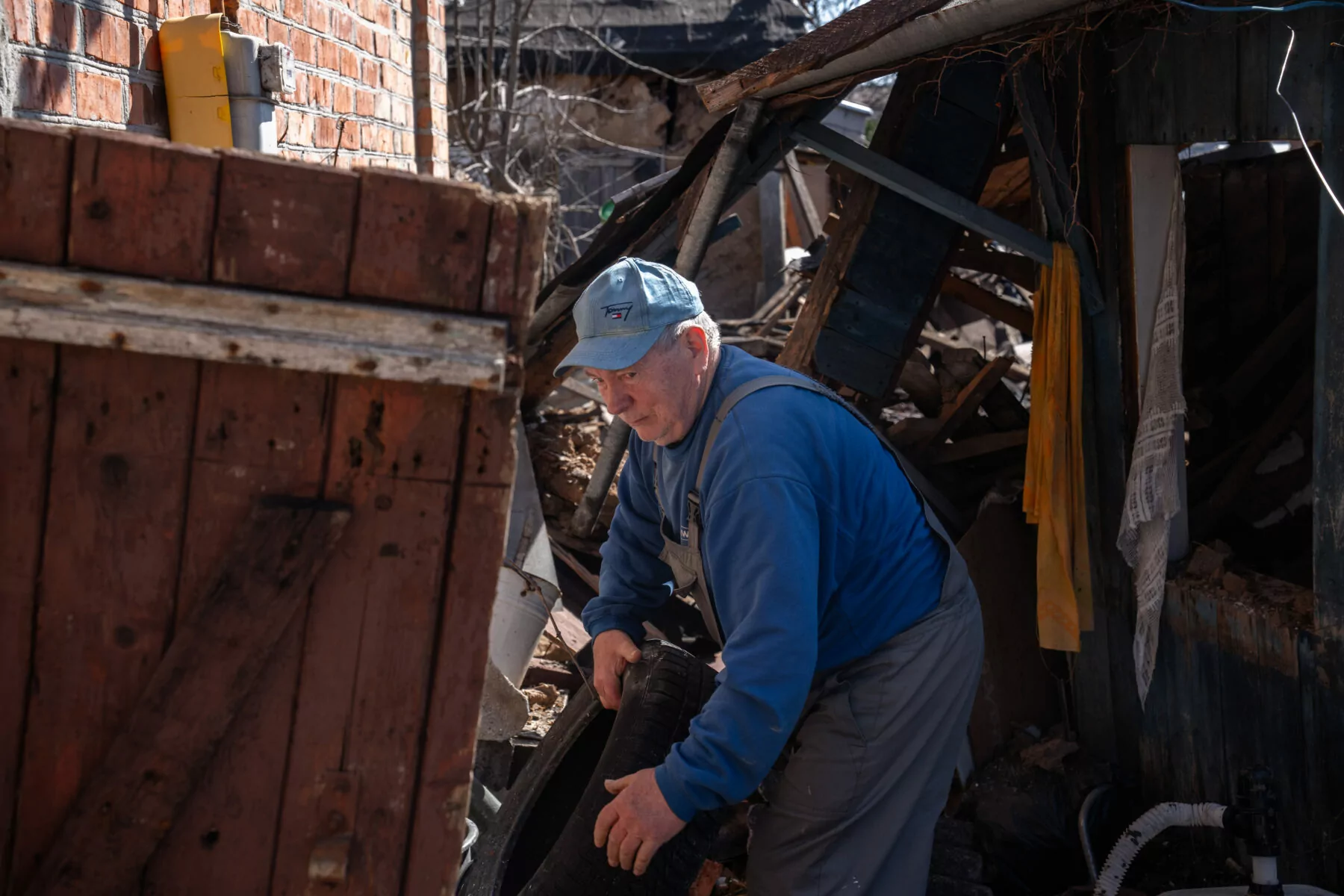 A local is cleaning up the aftermath of the Russian attack