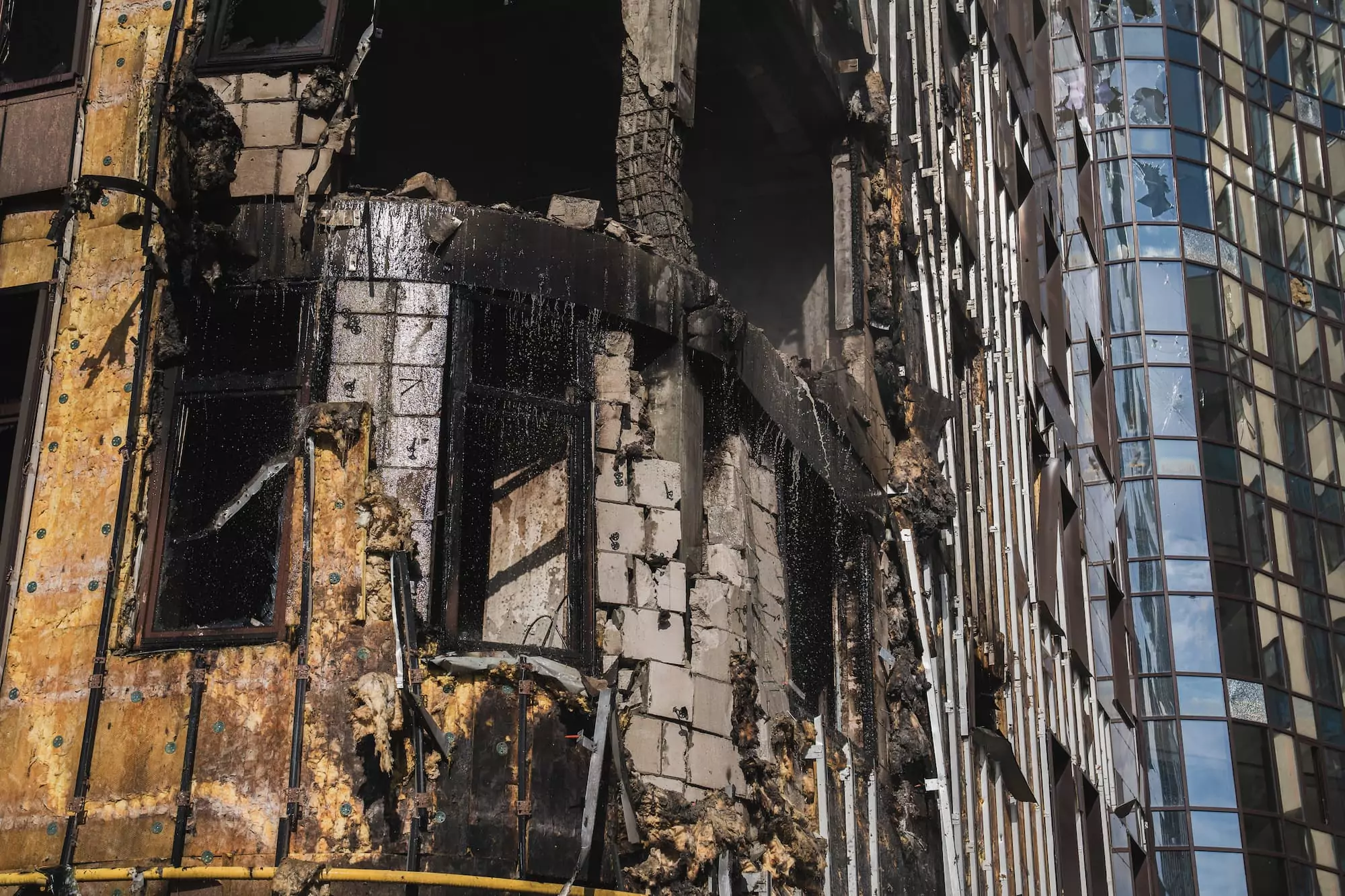 the damaged facade of the building in Kharkiv