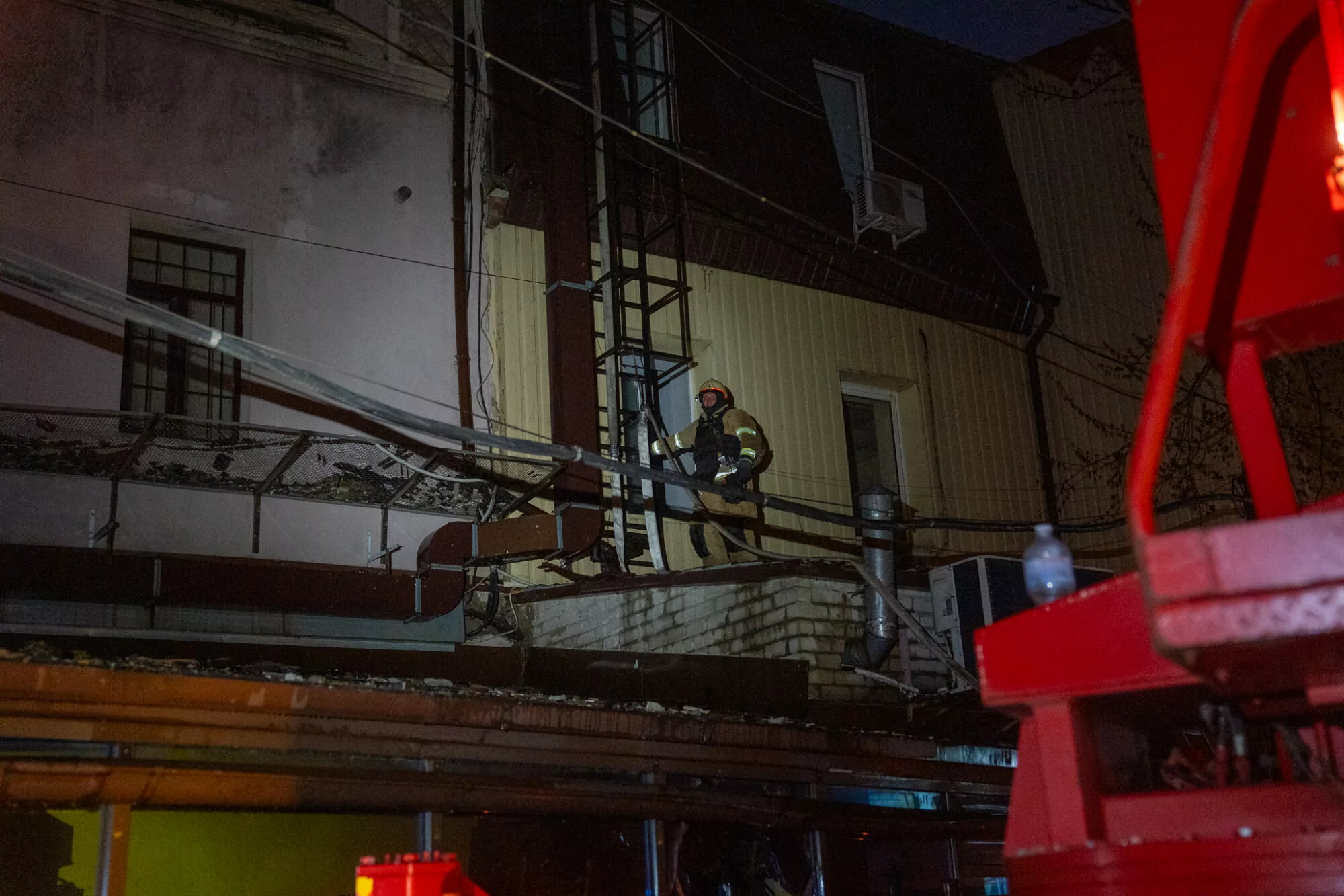 A firefighter puts out a fire after Russian attack on Kharkiv