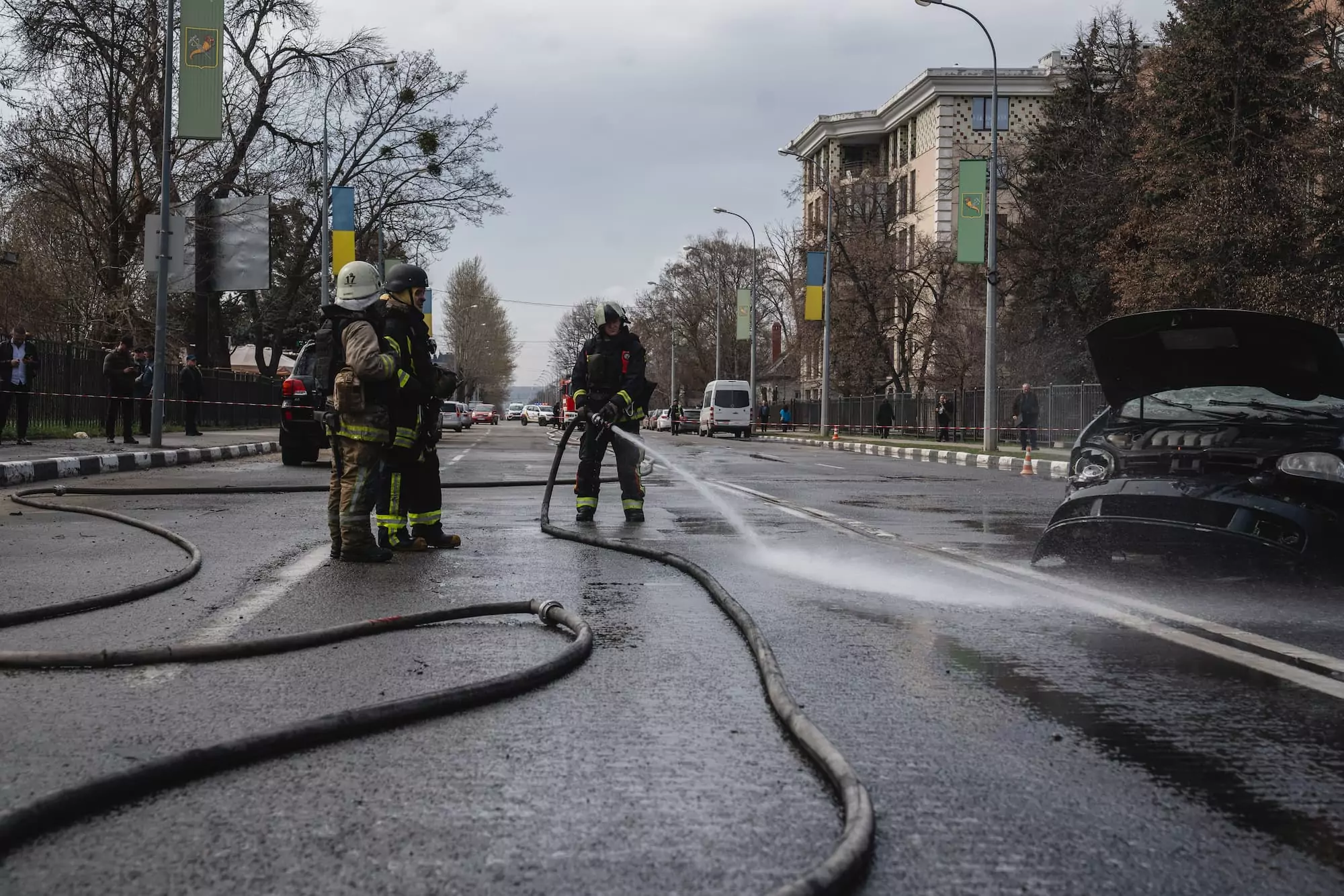 Firefighters are extinguishing burning cars after Russian attack on Kharkiv