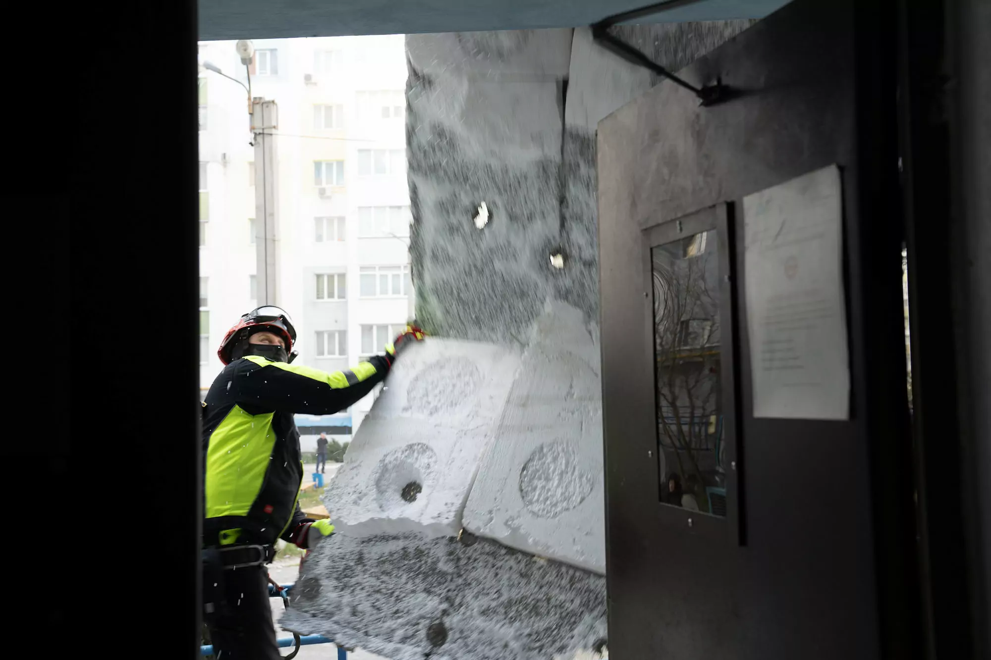 The rescue worker repairs the damage after Russian attack on Kharkiv