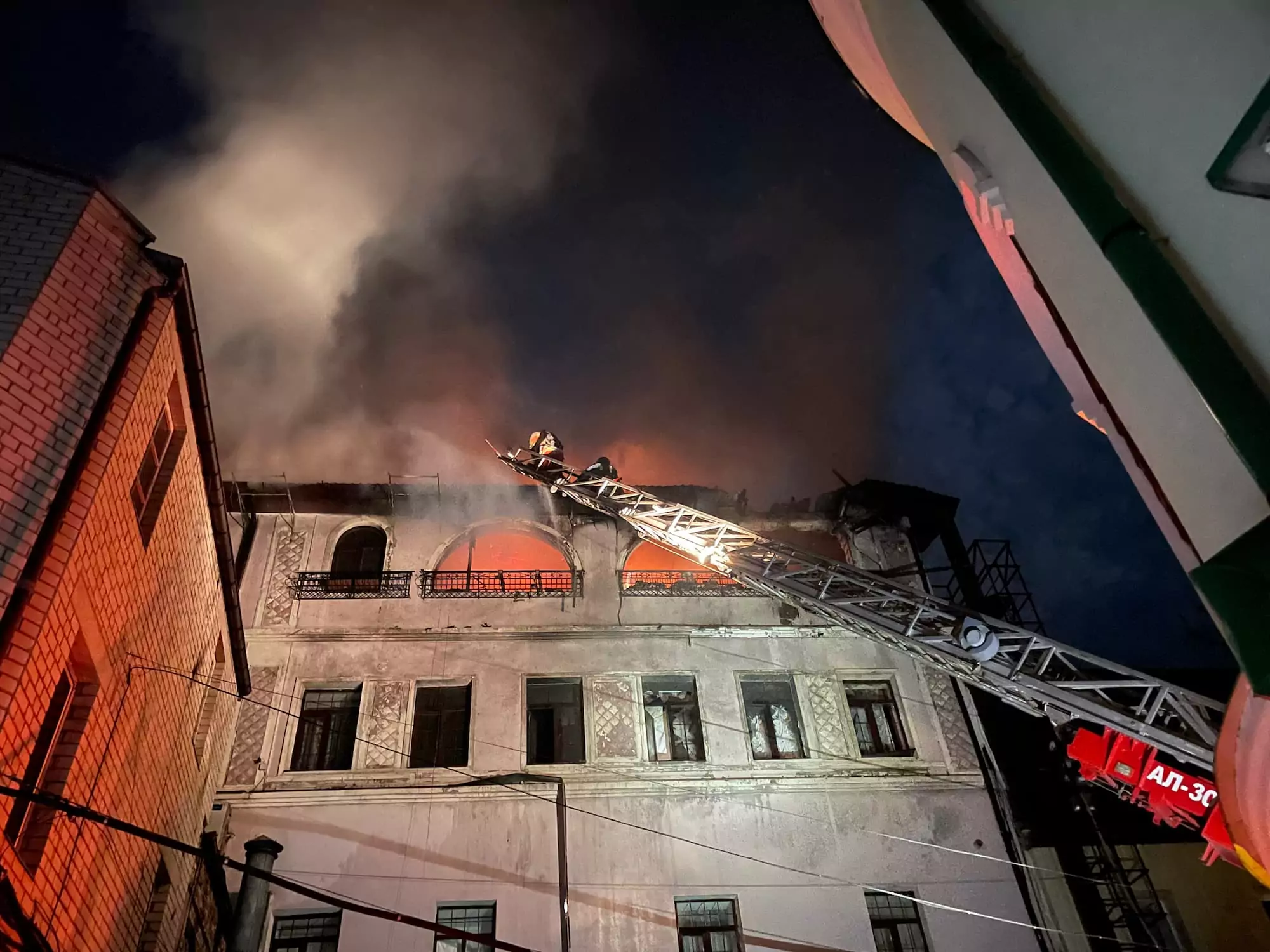A firefighter puts out a fire after Russian attack on Kharkiv