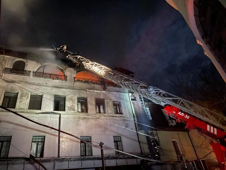 A firefighter puts out a fire after Russian attack on Kharkiv