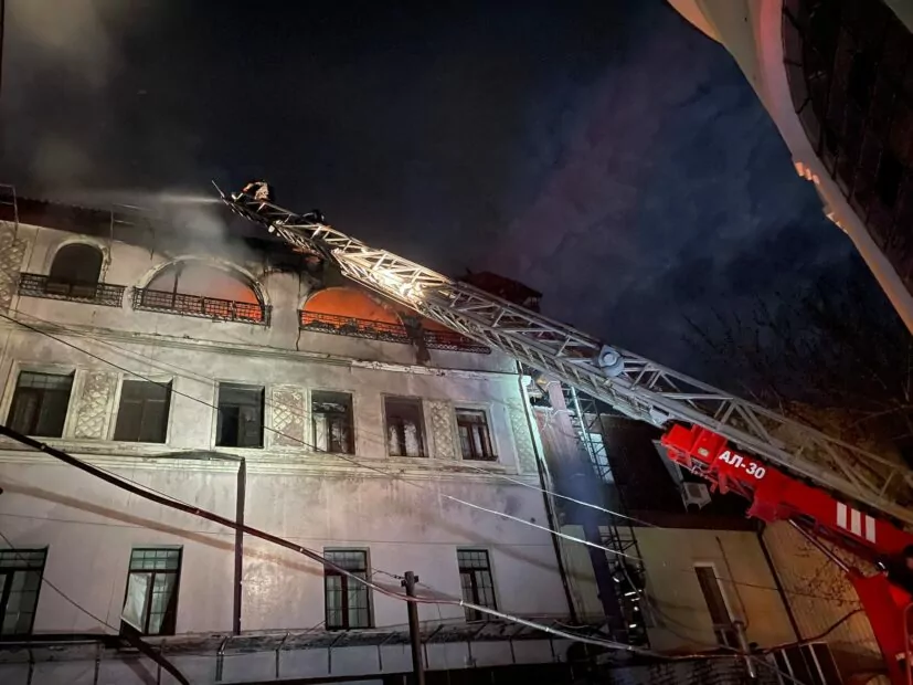 A firefighter puts out a fire after Russian attack on Kharkiv