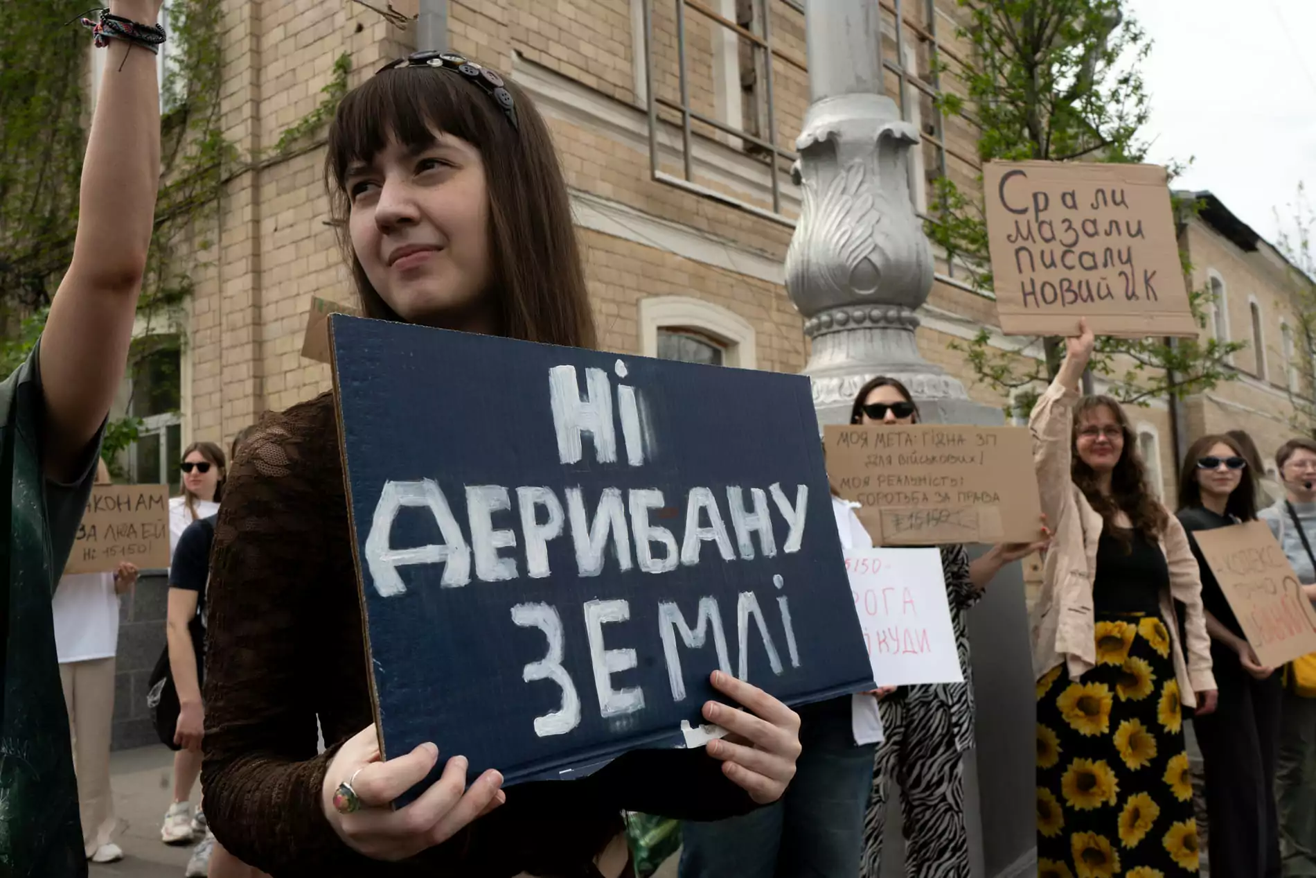 Participant of the protest against the draft Civil Code in Kharkiv, with their sign saying, "No to the land grabbing" / Photo: Gwara Media, Yana Sliemzina