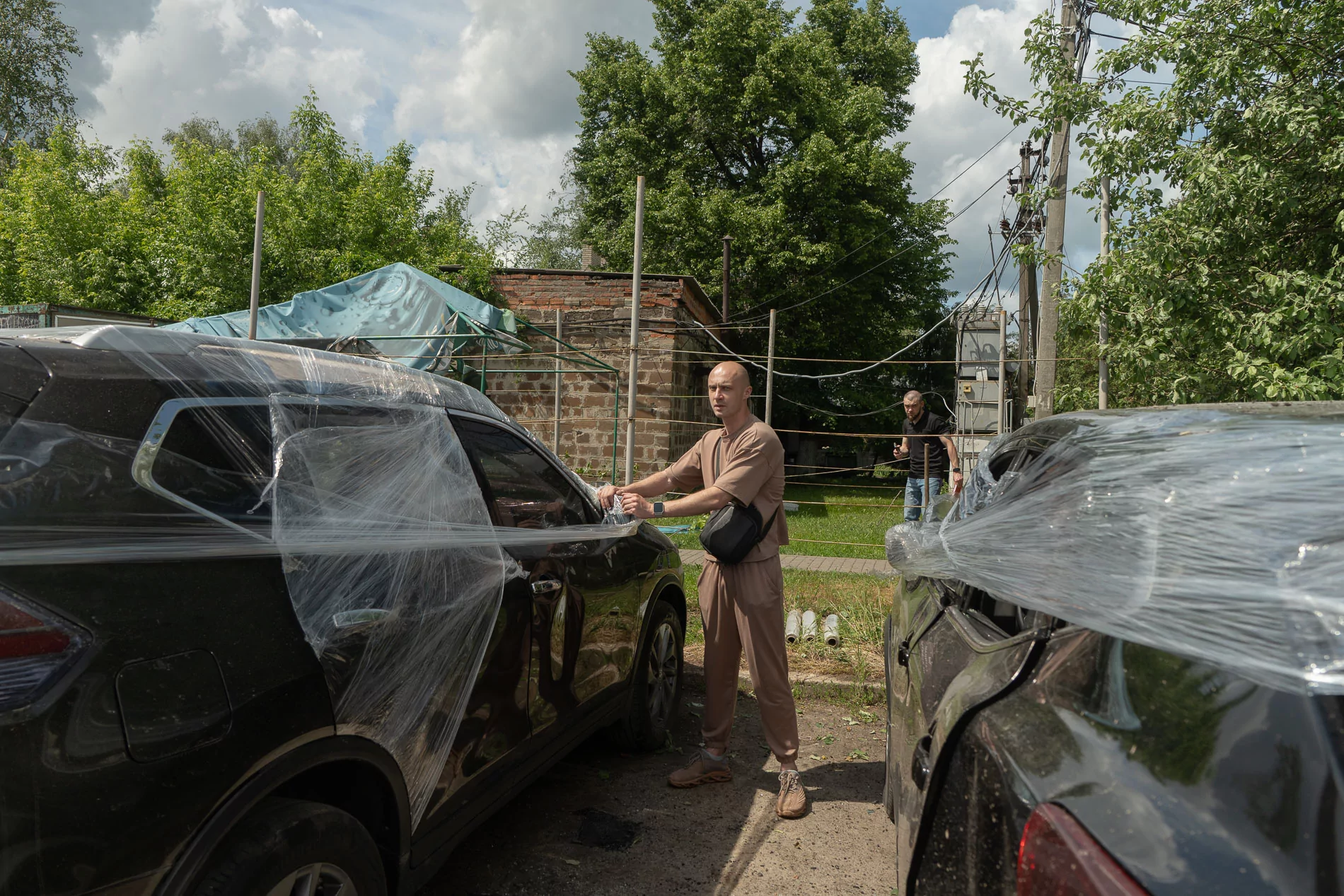 Damaged car and its owner after Russian attack