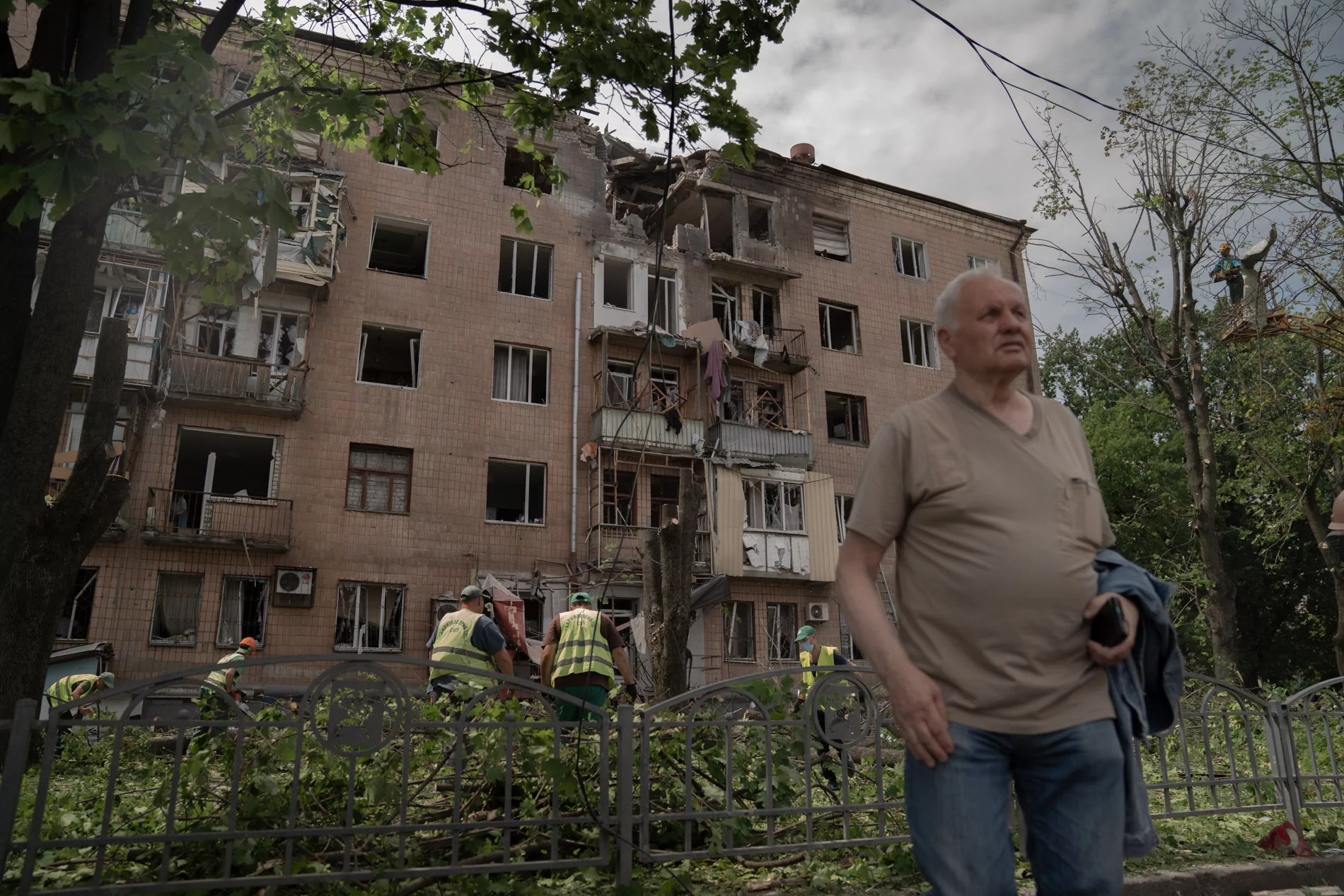A man near damaged building in Kharkiv