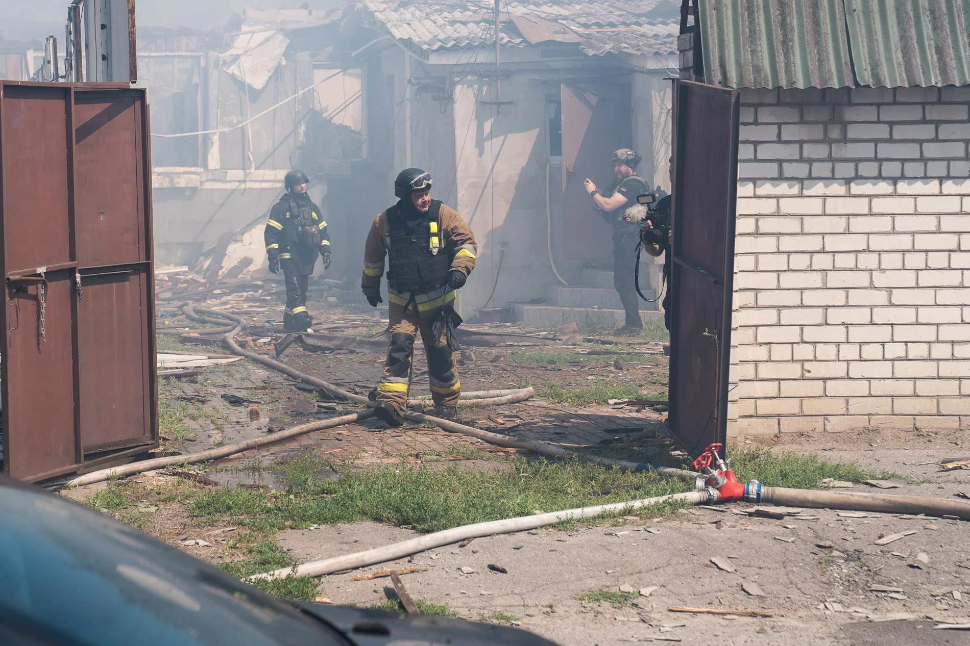 Firefighters in the courtyard of the damaged house in Kharkiv after the Russian airstrike on Aug. 10