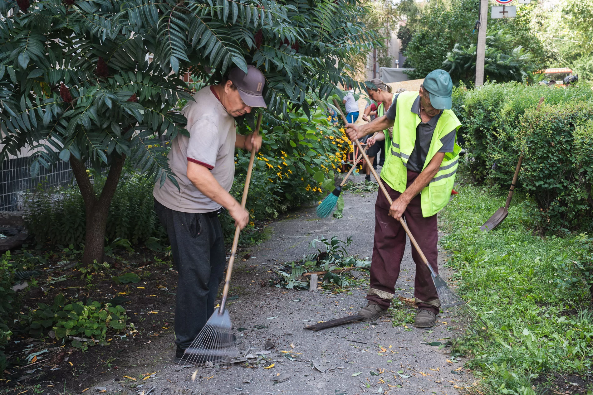 Municipal workers clean up the damage following Russian attack on Aug. 10