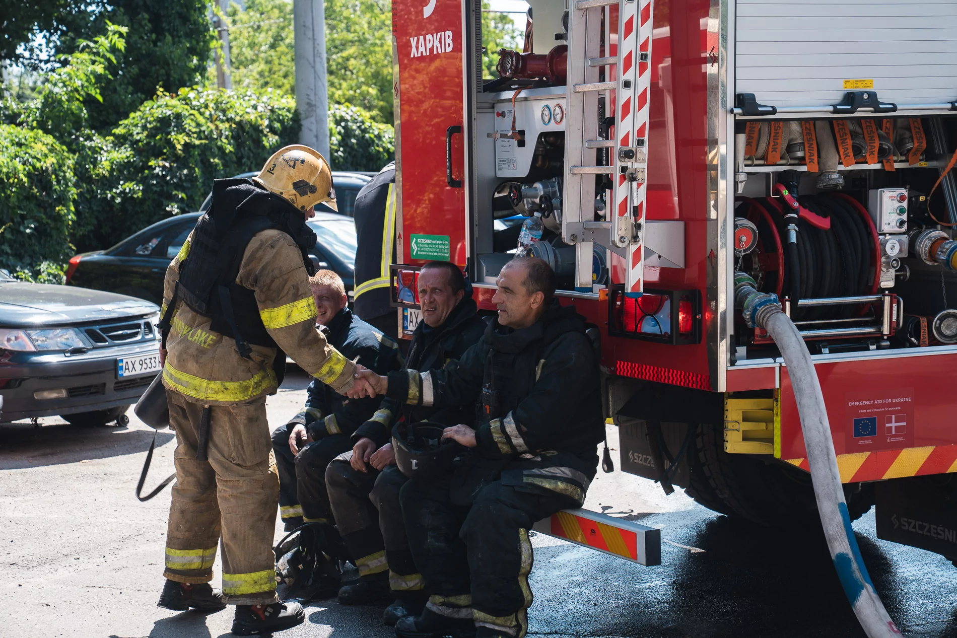 Firefighters are resting near the fire truck