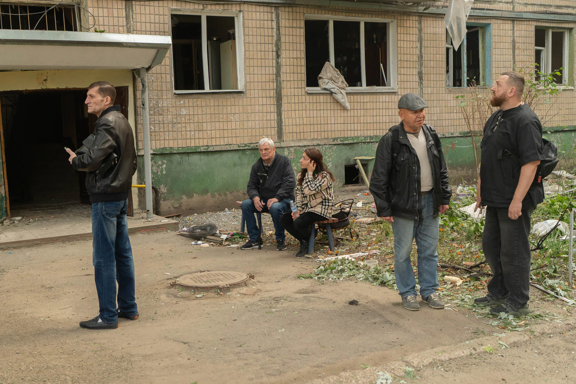Kharkiv locals near damaged building