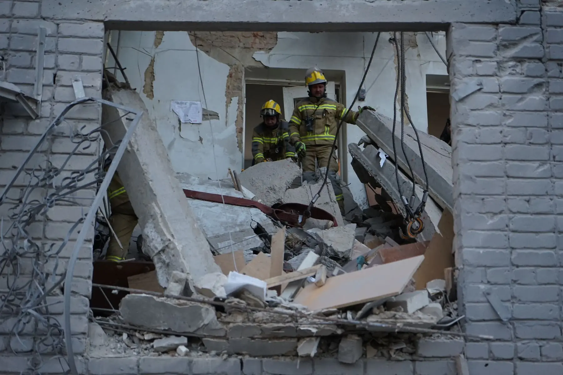 Rescuers in the destroyed part of the apartment building in Izium in the aftermath of Russian bombardment on Oct. 29, 2026